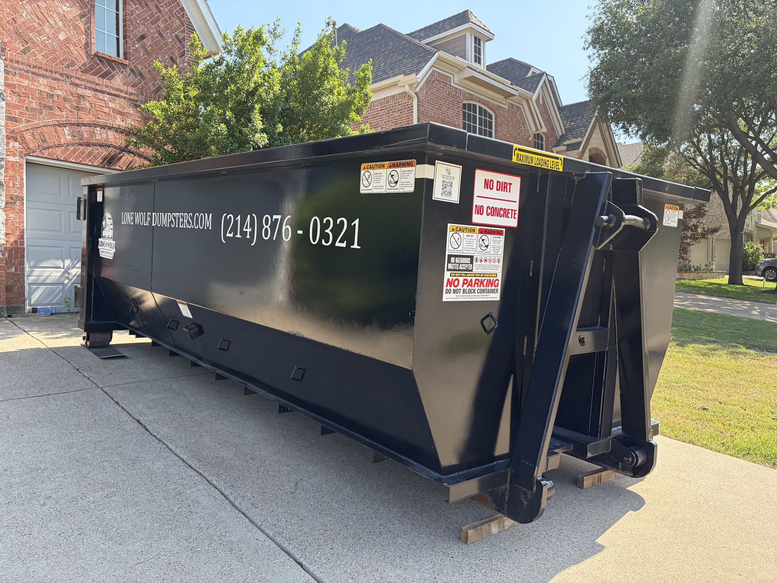 Real Lone Wolf Dumpster Delivery on Texas Driveway